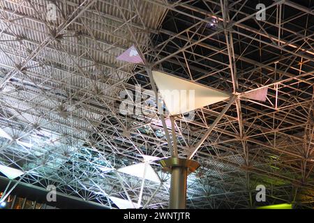 Metal structures under the ceiling. Decorative details of the airport ceiling . Concrete beams, glass windows and metal elements as public building Stock Photo