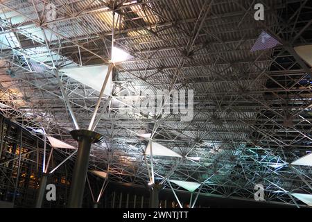 Metal structures under the ceiling. Decorative details of the airport ceiling . Concrete beams, glass windows and metal elements as public building Stock Photo