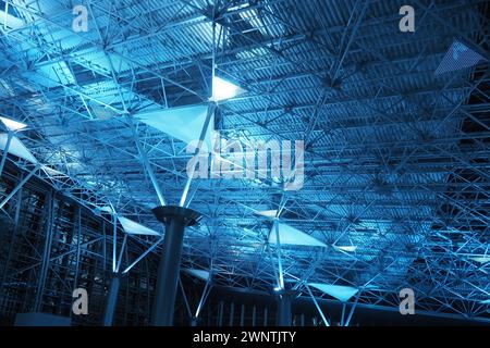 Metal structures under the ceiling. Decorative details of the airport ceiling . Concrete beams, glass windows and metal elements as public building Stock Photo