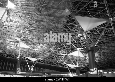 Metal structures under the ceiling. Decorative details of the airport ceiling . Concrete beams, glass windows and metal elements as public building Stock Photo