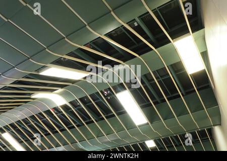 Metal structures under the ceiling. Decorative details of the airport ceiling . Concrete beams, glass lusters and metal elements as public building Stock Photo