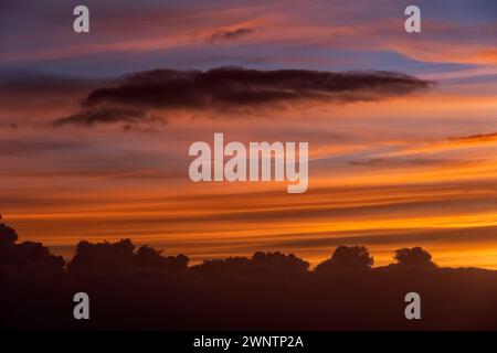 Sky at sunset with smooth and stormy clouds, natural cloudscape background. Stock Photo