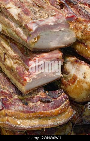 Homemade roasted barbecued pork on a meat market counter, close-up shot, abstract food background Stock Photo