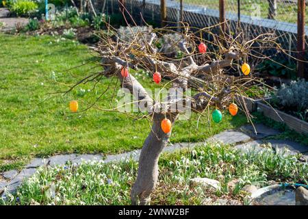 Tree in the garden with colorful Easter eggs Stock Photo