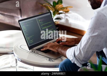 Developer programmer writing html javascript code in a laptop. Stock Photo