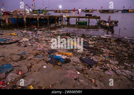 The dirty beach of the fishing harbor of Hoi An in Vietnam Stock Photo