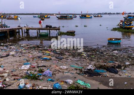 The dirty beach of the fishing harbor of Hoi An in Vietnam Stock Photo