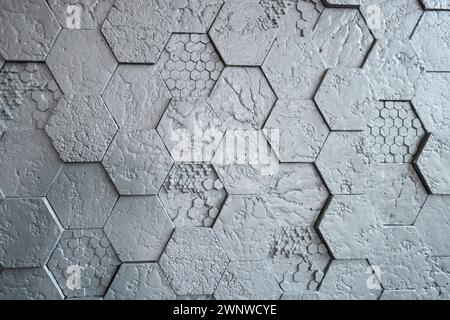 Background made of grey hexagonal gypsum tiles, textured, mosaic. Modern renovation. Stock Photo
