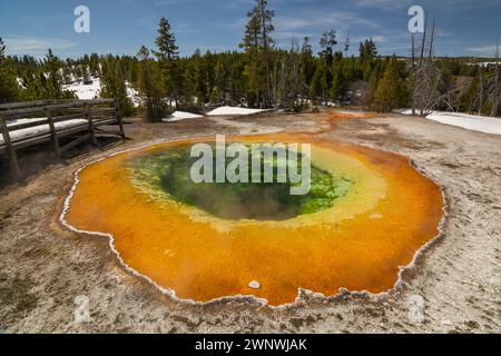 The image showcases the vibrant colors of a hot spring with striking green and orange mineral deposits around the edges Stock Photo