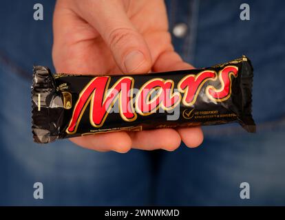 Tambov, Russian Federation - January 23, 2024 A woman holding Mars chocolate bar in her hand Stock Photo