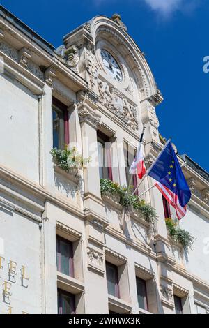 Europe, France, Centre-Val de Loire, Montrichard Town Hall (La Mairie de Montrichard Val de Cher) showing detail of Flags and Clock Stock Photo