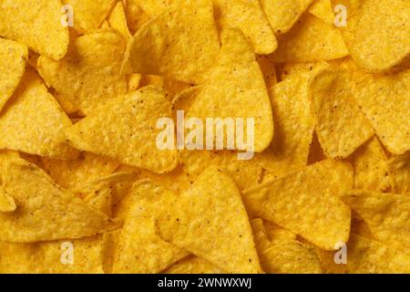 Mexican triangle Tortilla Nacho Cheese Chips close up full frame as background Stock Photo