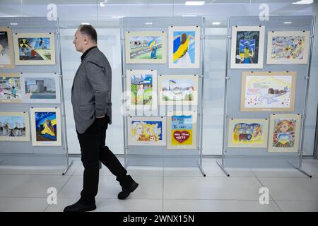 Kyiv, Ukraine. 04th Mar, 2024. Nuclear plant worker walks near children's drawings about the occupation of Zaporizhzhia station at an event dedicated to commemorating the second anniversary of the occupation by Russian armed forces of Zaporizhzhia Nuclear Power Plant, in Kyiv. Zaporizhzhya Nuclear Power Plant was occupied by Russian troops on March 4, 2022. (Photo by Oleksii Chumachenko/SOPA Images/Sipa USA) Credit: Sipa USA/Alamy Live News Stock Photo