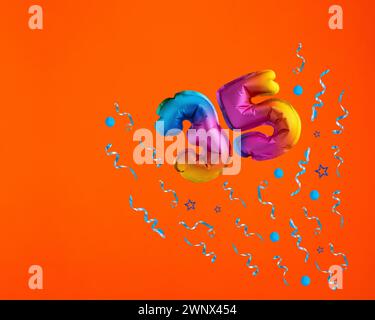 Confetti explosion with number 35 balloon - Celebration on orange background. Birthday card Stock Photo