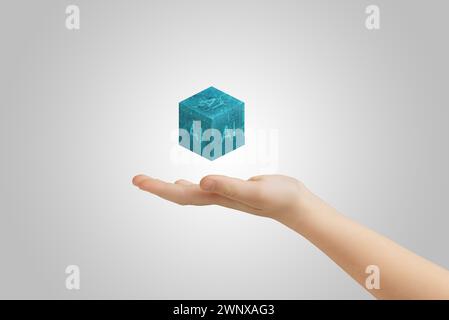 Hand presenting levitating cube with AI text, illustrating artificial intelligence advancements Stock Photo