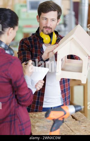 carpenter in workshop making a birdhouse Stock Photo