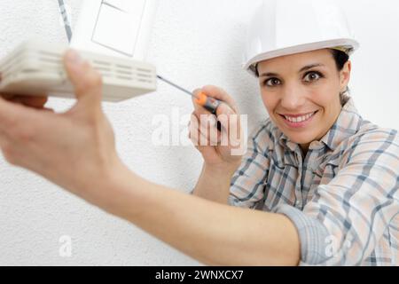 female construction worker using a screw driver Stock Photo