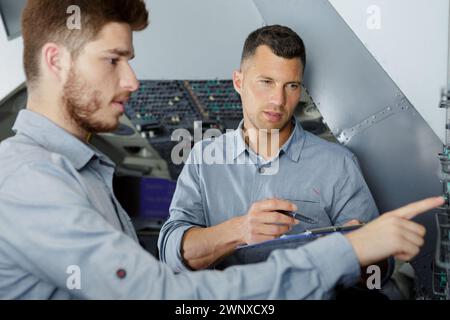 apprentice engineer working on control panel Stock Photo