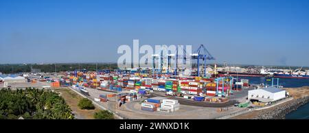 Puerto Quetzal, Guatemala - 19 January 2024: Panoramic view of shipping containers in the city's port with container cranes in the background Stock Photo