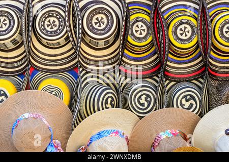 Close up view of a selection of colourful straw hats on sale in a market Stock Photo