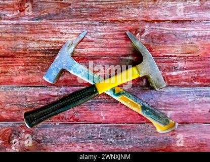 Two hammers on wooden background, tinted image, close-up Stock Photo