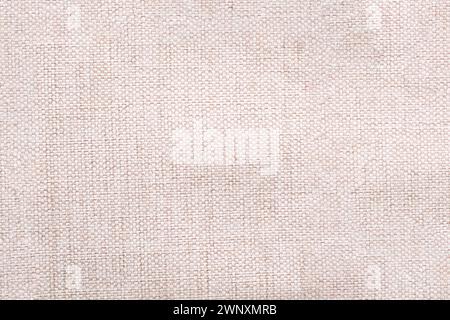 Natural linen material textile canvas Fabric texture background Close-up detail of fabric natural color Hemp material pattern design wallpaper. Stock Photo