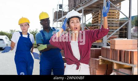 Taskmaster amazed by something in outdoor warehouse Stock Photo