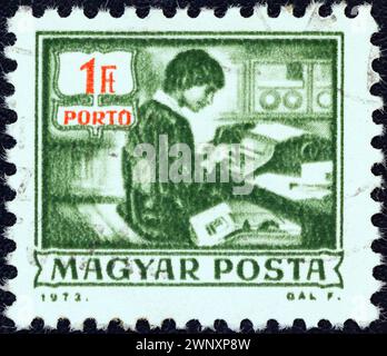 HUNGARY - CIRCA 1973: A stamp printed in Hungary from the 'Postal Operations' issue shows data recording machine, circa 1973. Stock Photo