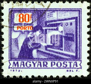 HUNGARY - CIRCA 1973: A stamp printed in Hungary from the 'Postal Operations' issue shows automatic parcels registration machine, circa 1973. Stock Photo
