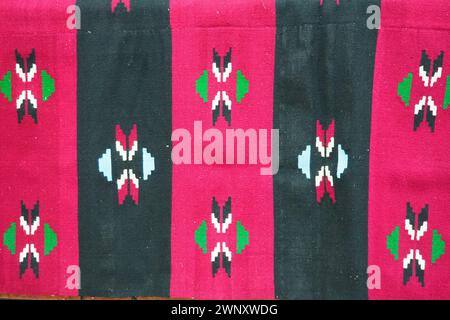 Hand woven kilim pattern. Serbian traditional national folk pattern on the carpet. Red, pink and black vertical stripes. Rhombic decorative Stock Photo