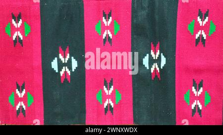 Hand woven kilim pattern. Serbian traditional national folk pattern on the carpet. Red, pink and black vertical stripes. Rhombic decorative Stock Photo