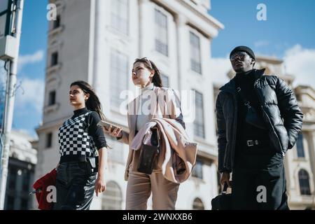 Confident young business partners walking in urban setting. Stock Photo
