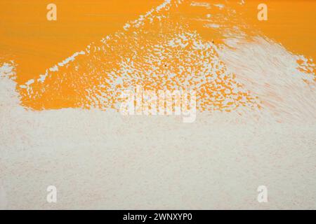 Orange white oil painting on plastered wall. Oil paint texture with brush and palette knife strokes. Modern art concept. Horizontal fragment. Stock Photo