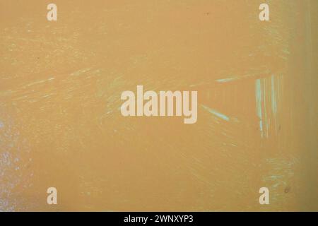 Orange oil painting on plastered wall. Oil paint texture with brush and palette knife strokes. Modern art concept. Horizontal fragment. Stock Photo