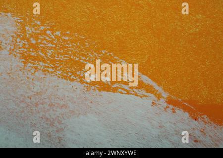 Orange white oil painting on plastered wall. Oil paint texture with brush and palette knife strokes. Modern art concept. Horizontal fragment. Stock Photo