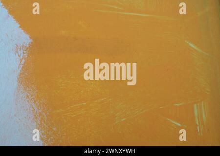 Orange white oil painting on plastered wall. Oil paint texture with brush and palette knife strokes. Modern art concept. Horizontal fragment. Stock Photo