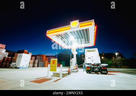 Shell HGV filling station, diesel only. A driver fills his HGV or lorry tractor unit with diesel at the end of the day. Manchester Road, Bolton, UK Stock Photo