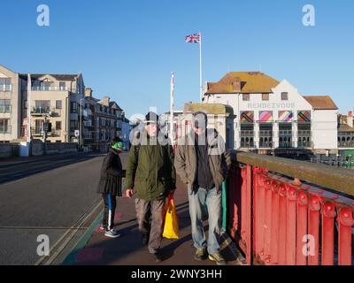 People walking across Weymouth Town Bridge in the Old Town of Weymouth, Dorset, England, United Kingdom. Stock Photo