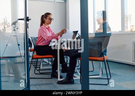 In a sleek, modern glass office, the director engages in a productive discussion with an employee, focusing on business projects and fostering Stock Photo