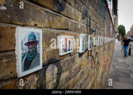 Colourful portaits of East End residents celebrating the diversity of London at an open air street art gallery on a wall in the Brick Lane area Stock Photo