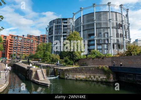 The historic St. Pancras Lock and the neighbouring former gas holders that were converted into apartment houses at former King's Cross coal drops yard. Stock Photo