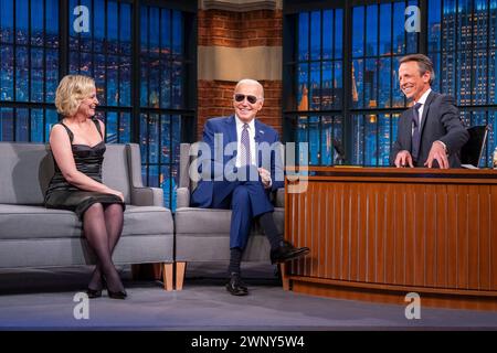 New York City, United States of America. 26 February, 2024. U.S President Joe Biden, wearing his trademark Rayban Aviator sunglasses, makes an appearance on “Late Night with Seth Meyers” with host Seth Meyers, right, and guest Amy Poehler, left, at the NBC Late Night Studio at 30 Rockefeller Plaza, February 26, 2024 in New York City.  Credit: Adam Schultz/White House Photo/Alamy Live News Stock Photo