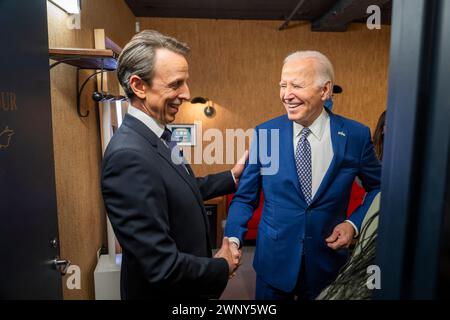 New York City, United States of America. 26 February, 2024. U.S President Joe Biden, right, shakes hands with host Seth Meyers, left, before appearing on “Late Night with Seth Meyers” at the NBC Late Night Studios, 30 Rockefeller Plaza, February 26, 2024 in New York City.  Credit: Adam Schultz/White House Photo/Alamy Live News Stock Photo