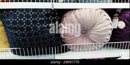 Sremska Mitrovica, Serbia, 03 December 2021. Decorative pillows on a shelf in a store. Beautiful textile pillows for sofa and trendy interior Stock Photo