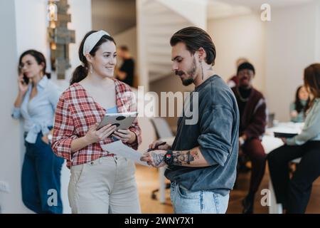 Confident business employees discussing and analyzing project reports for successful expansion. Stock Photo