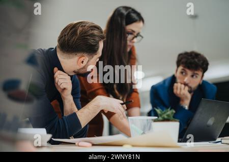 Successful Corporate Team Gathered at Table for Brainstorming and Discussing Business Strategies Stock Photo