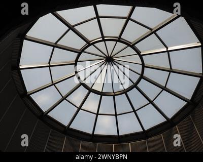 Glass dome or round window in the roof. The sky can be seen through a glass transparent structure in the vault of the building. Architectural fashion Stock Photo