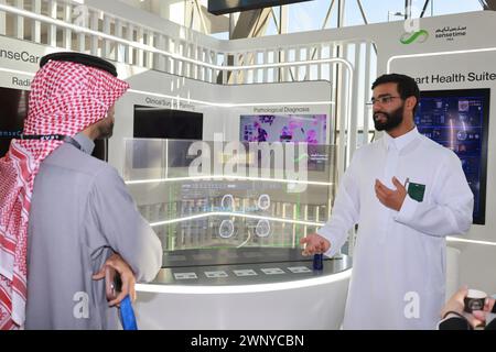 Riyadh, Saudi Arabia. 4th Mar, 2024. A visitor talks with an exhibitor at the LEAP 2024 in Riyadh, Saudi Arabia, on March 4, 2024. The LEAP Tech Conference 2024 kicked off here on Monday, aiming to attract 11.9 billion U.S. dollars in investments, according to the press release issued by the organizing committee. Credit: Wang Haizhou/Xinhua/Alamy Live News Stock Photo