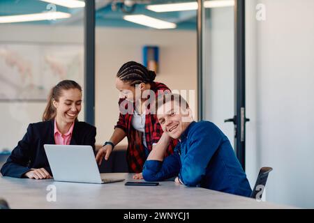 A team of successful programmers sits in a startup office, strategizing new business projects and solving existing challenges, showcasing innovation Stock Photo