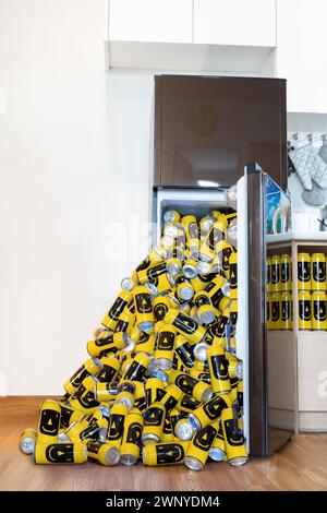 A pile of beer cans fallen out of the fridge Stock Photo